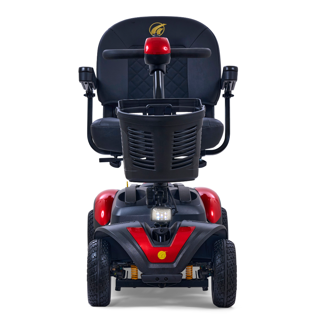 The Golden Tech GB148 Buzzaround EX is a red and black four-wheel mobility scooter with a comfortable seat, backrest, and control panel on the handlebars. It includes a basket below the steering. Its sturdy yet compact design ensures accessibility and easy maneuverability.