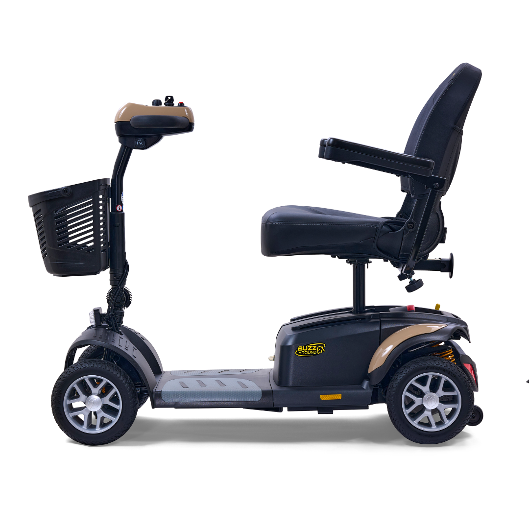 Side view of the Golden Tech GB148 Buzzaround EX Portable Mobility Scooter, a full-size model with four wheels and a front basket. It has a black seat with armrests, handlebars for steering, and a metallic footrest. The frame is mostly black with beige accents.