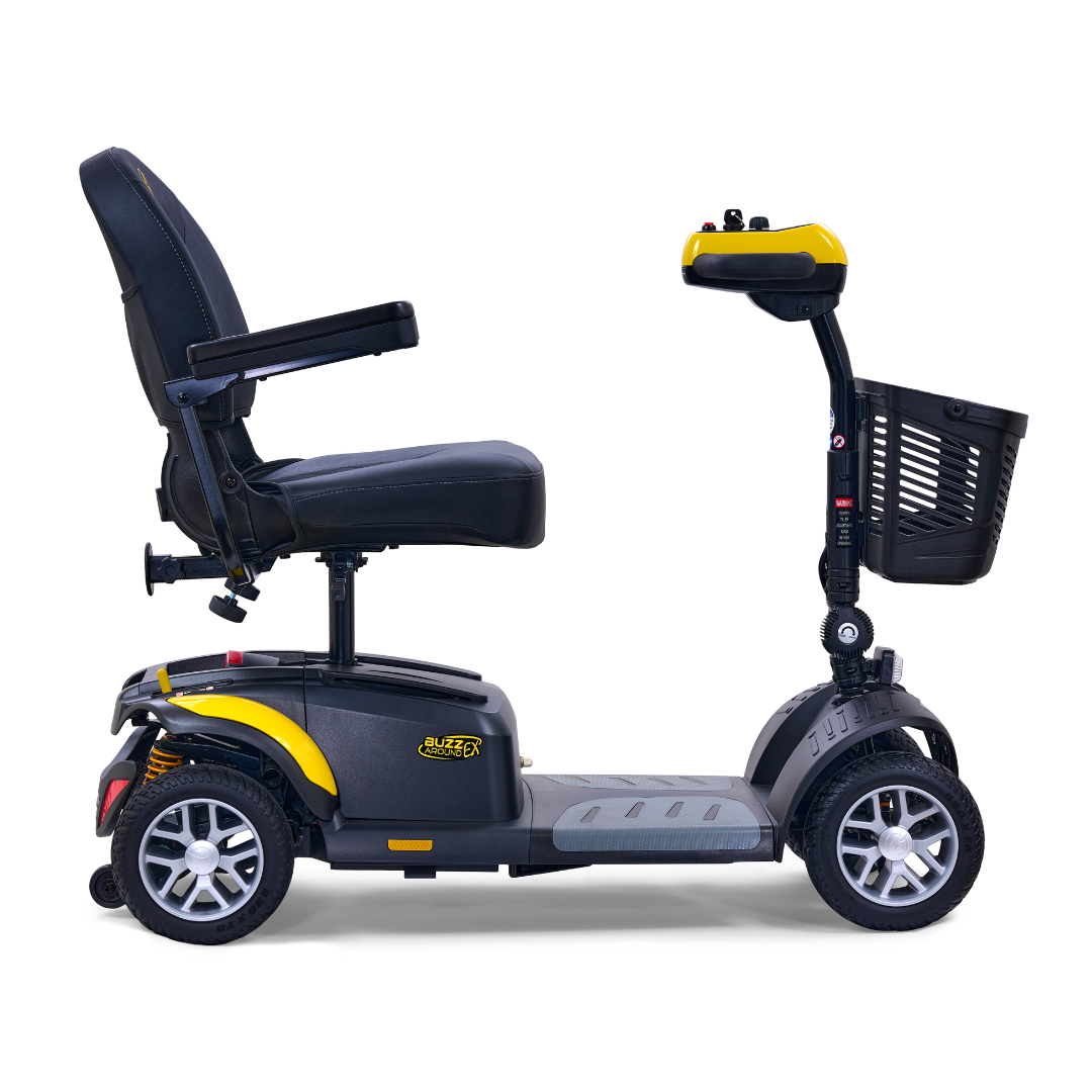 The Golden Tech GB148 Buzzaround EX Portable Mobility Scooter in yellow and black features a side view with a comfortable black seat, armrests, four wheels for stability, and a small front basket. It offers easy steering with its convenient handles.