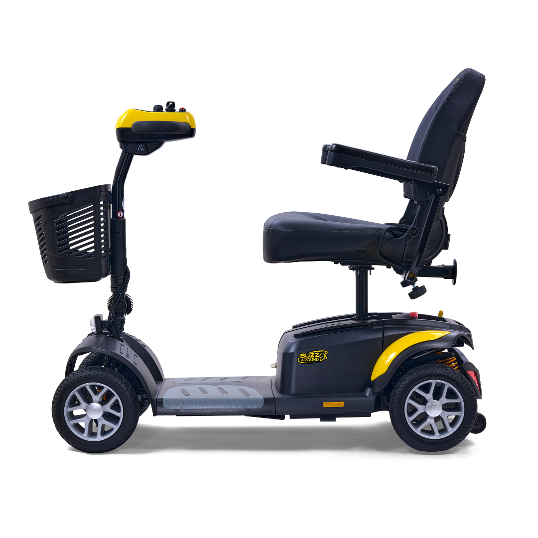 A side view of the Golden Tech GB148 Buzzaround EX Portable Mobility Scooter shows its four-wheel design in black and yellow with a front basket. The compact full-size scooter features armrests for comfort, blending style with practicality.