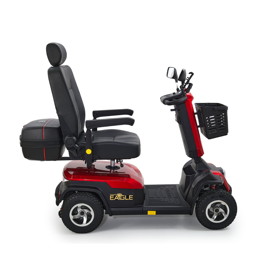 The Golden Tech Eagle HD Bariatric 4-Wheel Scooter with Suspension, in red and black, is designed for outdoor adventure. It features a cushioned seat with armrests, headrest, front basket, and Eagle labeling on the side for comfortable, capable off-road performance.