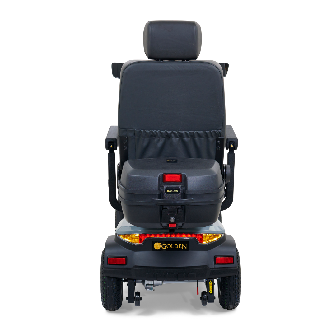 A rear view of the black Golden Tech Eagle HD Bariatric 4-Wheel Scooter features a padded seat, headrest, and back storage. Designed for outdoor adventure with off-road capabilities, its performance ensures smooth travel. The brand Golden appears below the seat.