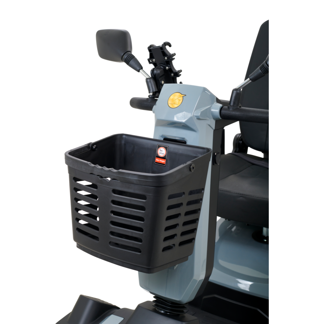 A close-up of the Golden Tech Eagle HD Bariatric 4-Wheel Scooter with Suspension reveals its front basket, ideal for off-road use. The black slotted basket matches the scooters gray and black look, along with a rearview mirror and comfy seat.