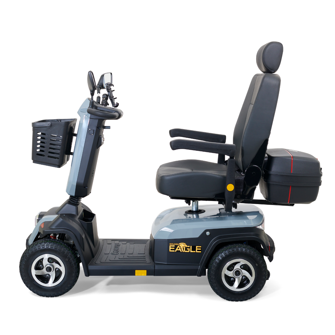The Golden Tech Eagle HD Bariatric 4-Wheel Scooter with Suspension features a cushioned seat and backrest. Its sleek black frame, display, handlebars, and armrests ensure comfort and off-road capability. A small front basket and rear storage labeled Eagle complete its design.