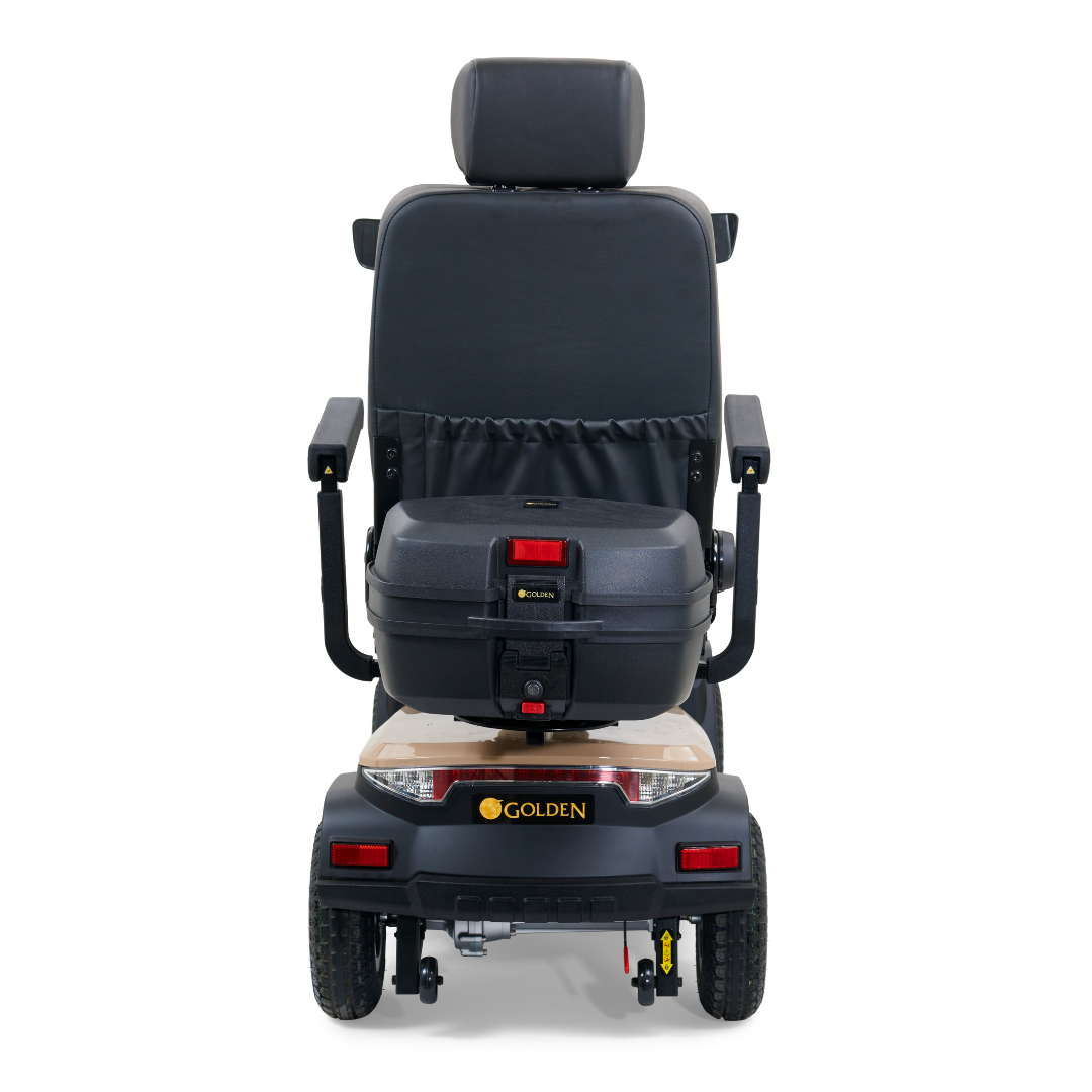 From the rear, the Golden Tech Eagle HD Bariatric 4-Wheel Scooter hints at off-road adventure with its padded seat, headrest, armrests, brake lights, and solid build. The storage compartment and suspension enhance its appeal for outdoor escapades.