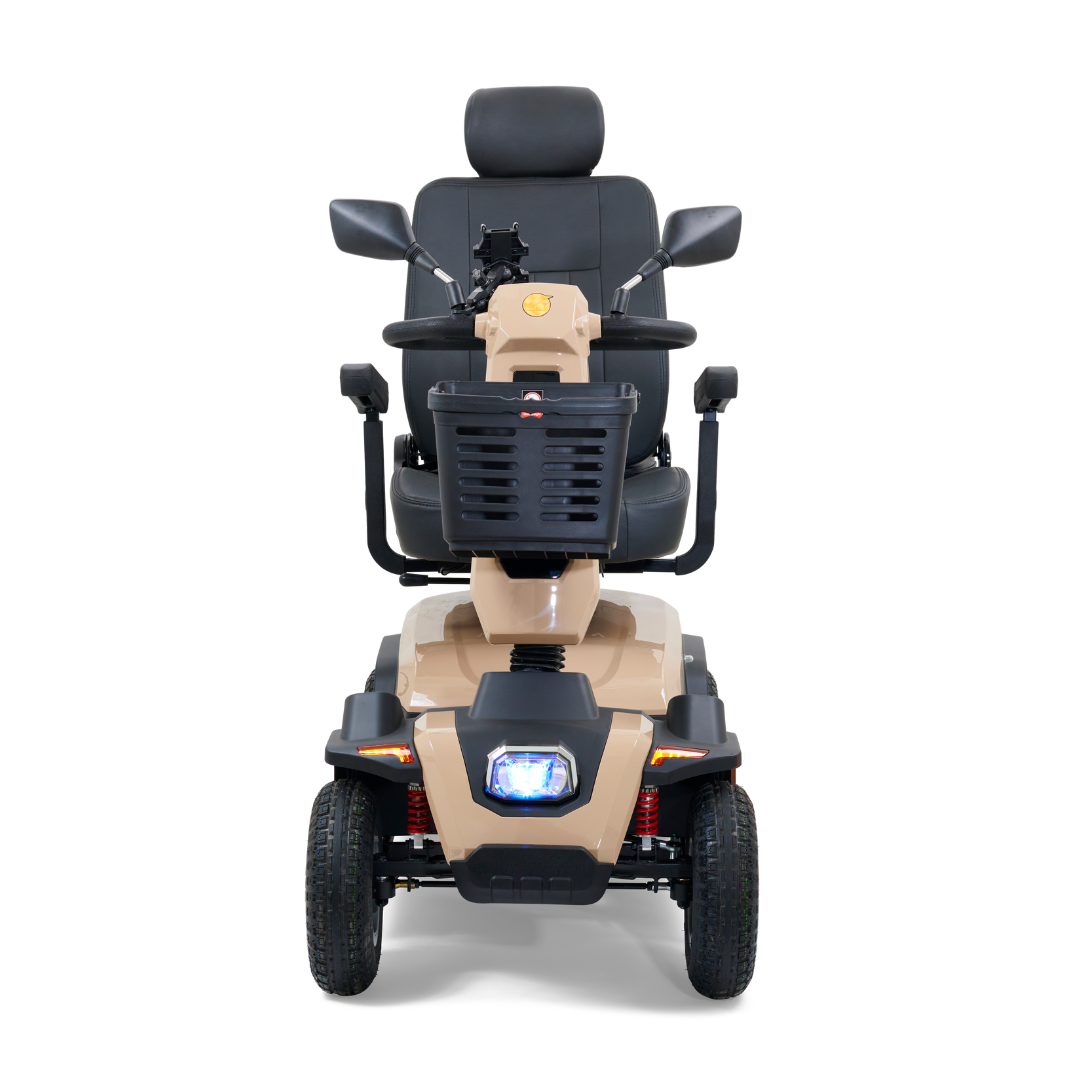 The front view of the Golden Tech Eagle HD Bariatric 4-Wheel Scooter with Suspension in beige shows a seat with armrests, rearview mirrors, and a headlight. Designed for off-road performance, it includes four wheels and a convenient front basket.
