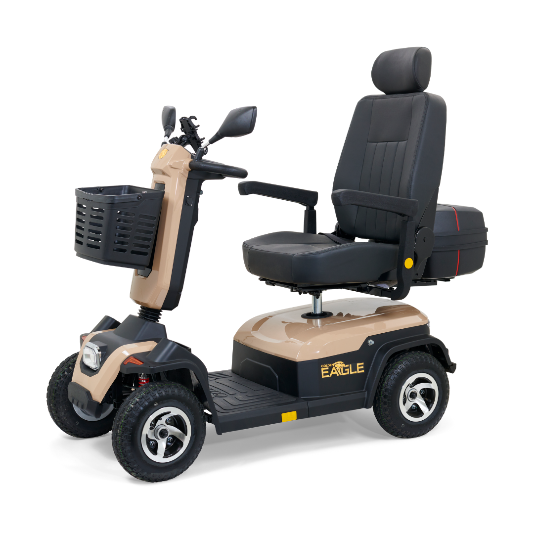 The Golden Tech Eagle HD Bariatric 4-Wheel Scooter with Suspension, ideal for outdoor adventures, has a tan and black design, off-road capabilities, padded seat with armrests, front basket, rearview mirrors, and displays Eagle on its side.