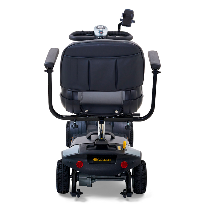 Rear view of the Golden Tech GB124 Buzzaround XL 4-Wheel Portable Mobility Scooter, featuring armrests, small wheels, a control panel, and the Golden brand name. Its sturdy design and headrest ensure better maneuverability, while the extended range battery supports longer journeys.
