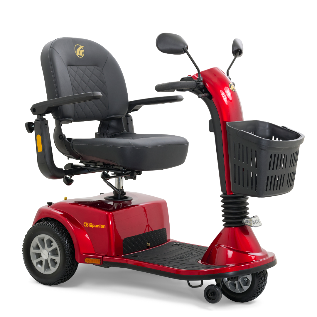 The Golden Tech GC240 Companion Mid-Size Mobility Scooter is a red, three-wheeled model with a black adjustable sliding seat. It includes a front basket and handlebars equipped with rear-view mirrors, featuring a compact, practical design that allows for easy disassembly.