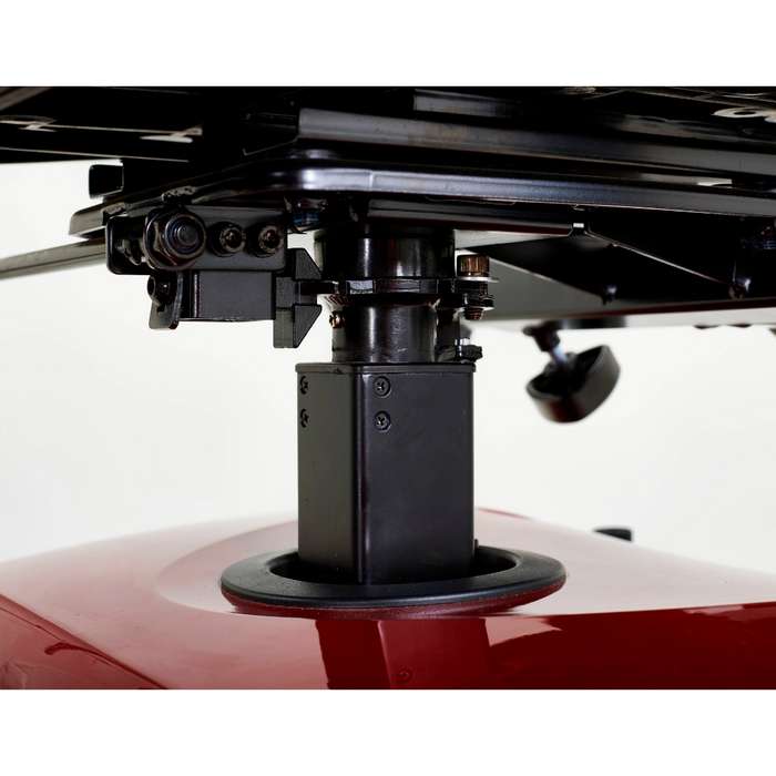 Close-up of a black mechanical component on the underside of an adjustable tiller, mounted on a red object. Includes screws and a cylindrical support, showcasing the Companion GC340 3-Wheel Scooter by Golden Tech against a plain white background.