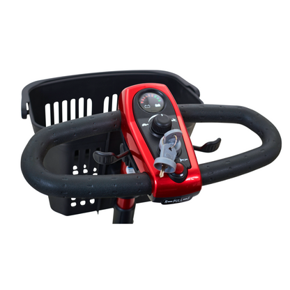 Close-up of a Golden Tech GL111 LiteRider 3-Wheel Mobility Scooters red handlebar with black textured grips, showcasing its Delta Tiller design with a central control panel, knob, display, and inserted keys. A black basket sits behind the handlebar.