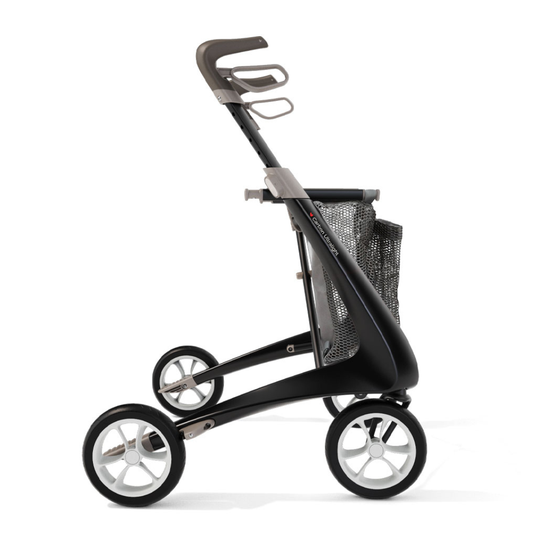 A modern black and gray rollator walker with four large wheels, ergonomic handles, a mesh storage basket, and the Grocery Bag For ByAcre Carbon Fiber Rollators for convenient shopping.