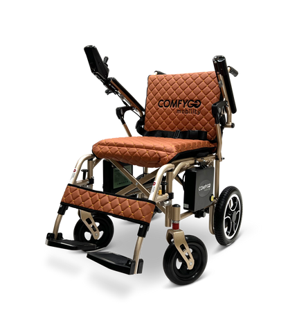 The ComfyGo X-7 electric wheelchair is a stylish, lightweight, and foldable model weighing just 40 lbs. It features a quilted brown seat and backrest, black armrests, a footrest, intricate wheel designs, and the Comfyg Mobility logo on the seat back.