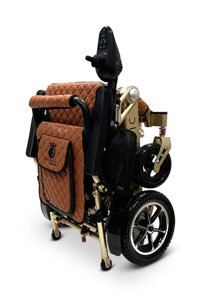 The MAJESTIC IQ-7000 Auto Folding Remote Controlled Electric Wheelchair features a brown quilted seat, gold frame, black wheels, and a 360-degree joystick control panel, set against a solid black background.