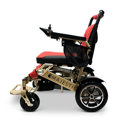 Side view of the sleek MAJESTIC IQ-7000 Auto Folding Remote Controlled Electric Wheelchair with a gold frame and black-and-red seat. Featuring a 360-degree joystick on the armrest, it includes auto-folding and a mesh storage bag. Lightweight wheels have shiny metallic rims.