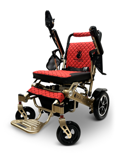 The MAJESTIC IQ-7000 is a luxury auto-folding electric wheelchair with a gold frame, red quilted cushioning, black accents, a footrest, and rugged wheels. It features a 360-degree joystick for superior control, offering stylish and comfortable mobility.