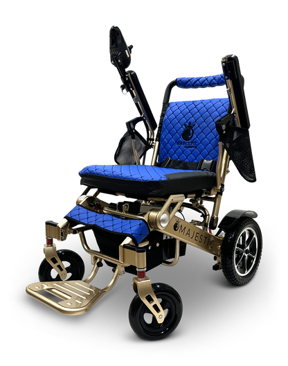 Introducing the MAJESTIC IQ-7000 Remote Controlled Electric Wheelchair, a contemporary blue and gold mobility solution featuring a luxurious quilted seat and backrest, large rear wheels for enhanced stability, and conveniently foldable armrests. Its lightweight design allows for effortless transport, proudly showcasing the Majestic brand logo on its frame.
