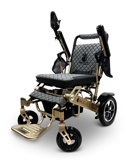 Introducing the MAJESTIC IQ-7000 Remote Controlled Electric Wheelchair, a stunning black and gold model featuring a quilted seat and backrest. It comes with foldable footrests and rear wheels adorned with hubcaps. This lightweight wheelchair boasts adjustable armrests and a modern design, making it the perfect blend of style and convenience for users.
