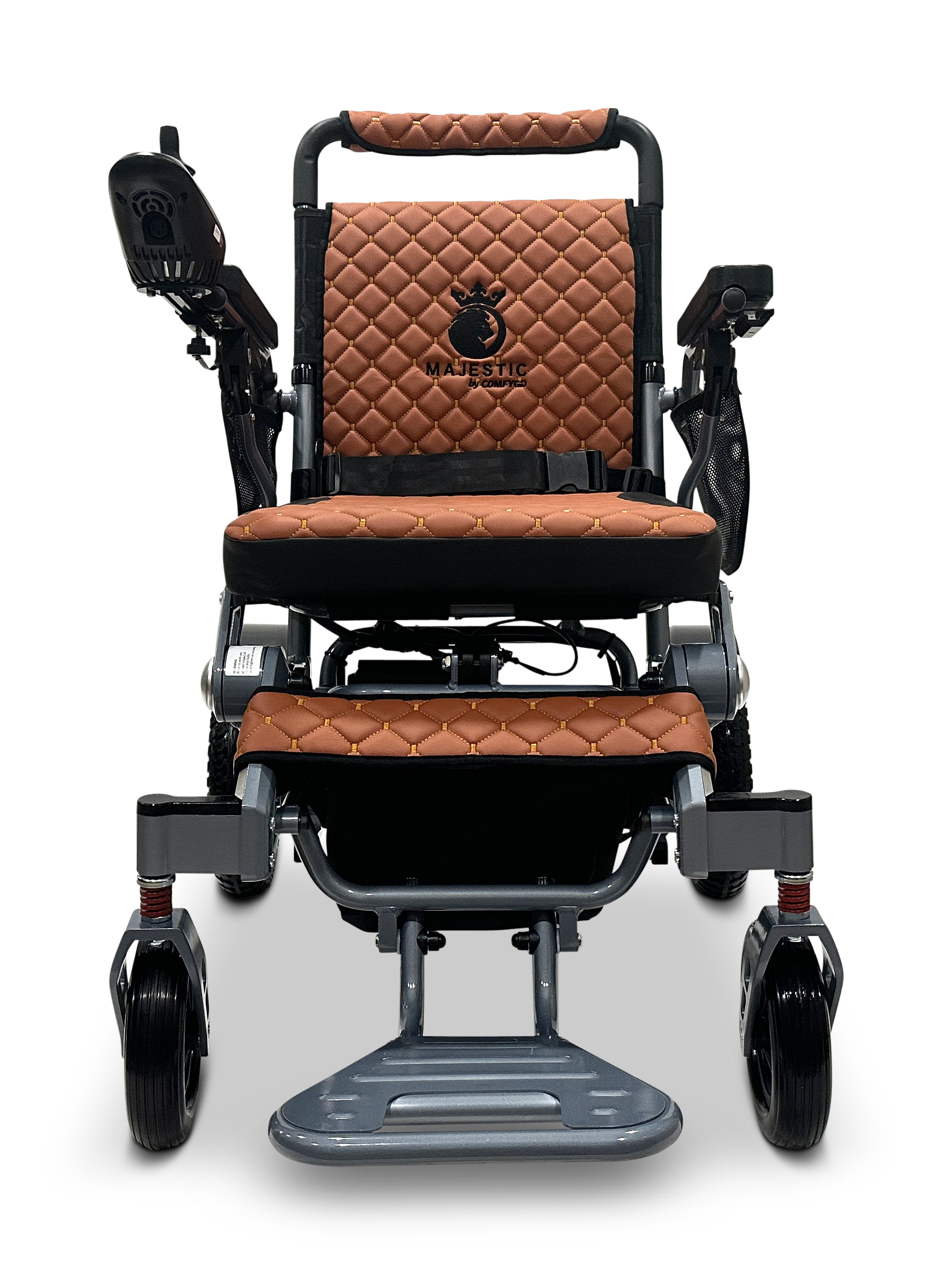 The MAJESTIC IQ-7000 Auto Folding Electric Wheelchair showcases brown quilted leather seating, a sleek black control panel on the armrest, Majestic elegantly embroidered with a crown logo, and a metallic frame with black and silver accents, plus a 360-Degree Joystick for easy navigation.