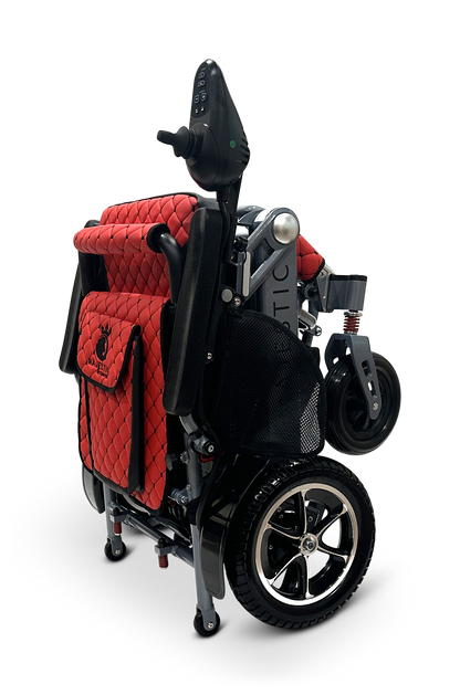 The MAJESTIC IQ-7000 is a compact, auto-folding electric wheelchair in striking red and black with a quilted seat cover. It has a 360-degree joystick on the armrest and sleek metallic wheels that pop against the plain black backdrop, enhancing its elegant design.
