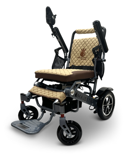The MAJESTIC IQ-7000 is a sleek, modern folding electric wheelchair with tan quilted cushioning, featuring a high backrest, adjustable armrests, and a metal footrest. It includes rugged wheels for enhanced mobility and a 360-degree joystick for effortless navigation.