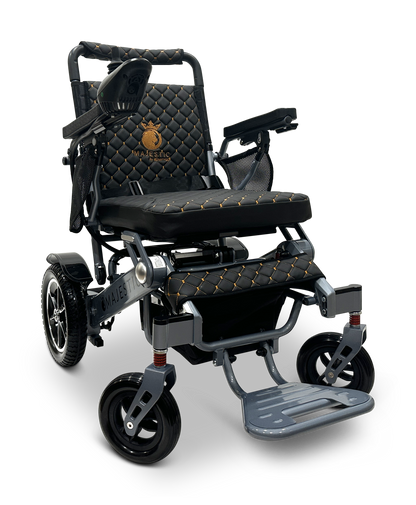 The stylish black and gold MAJESTIC IQ-7000 Auto Folding Remote Controlled Electric Wheelchair features a quilted seat, large rear wheels paired with smaller front ones for smooth navigation, a 360-degree joystick for control, armrests, and a foldable footrest for comfort.