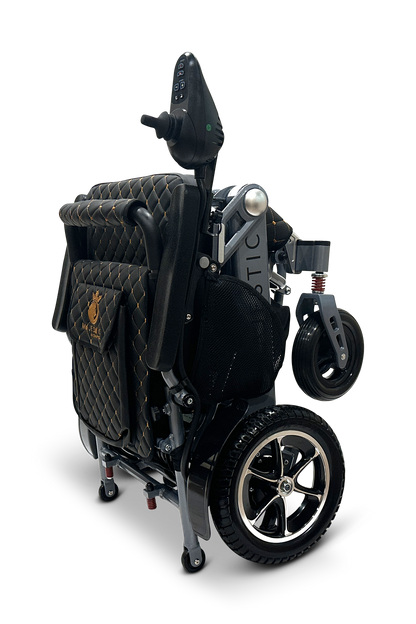 The MAJESTIC IQ-7000 is a compact, auto-folding electric wheelchair with a quilted seat and modern design. It features 360-degree joystick control, small front wheels, larger back wheels, and stands upright for easy storage and transport.