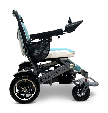 The MAJESTIC IQ-7000 Auto Folding Electric Wheelchair features a black and turquoise seat, a 360-degree joystick on the armrest, a mesh storage pocket at the back, and robust wheels for enhanced support.