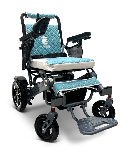 The MAJESTIC IQ-7000 is a blue and silver lightweight electric wheelchair with quilted padding, a 360-degree joystick on the right armrest, foldable footrests, black wheels, and a sleek logo on the backrest and seat.