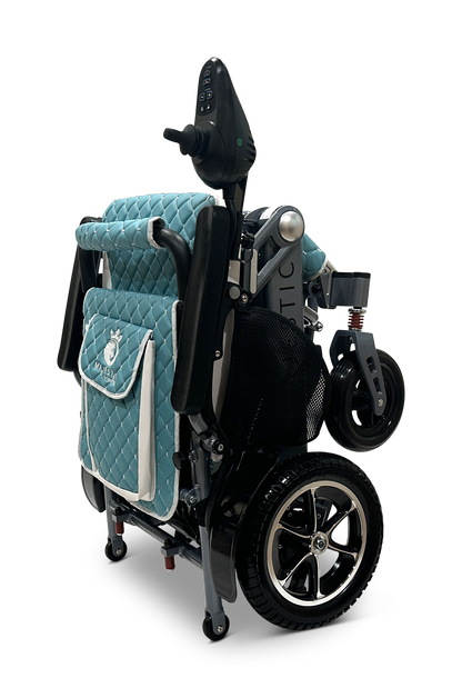 The MAJESTIC IQ-7000 Auto Folding Electric Wheelchair features a quilted teal cover, silver accents, 360-degree joystick control, small front wheels, larger rear wheels, and a rear storage pocket for easy transport and compact storage.