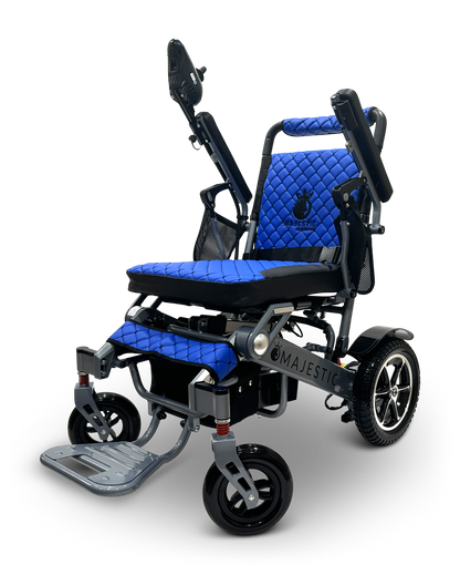The MAJESTIC IQ-7000 is a blue and black auto-folding electric wheelchair with a quilted design, featuring adjustable armrests, headrest, footrest, 360-degree joystick for enhanced control, and large rear wheels with smaller front wheels for smooth mobility.