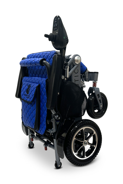 The MAJESTIC IQ-7000 is a lightweight, auto-folding electric wheelchair with a quilted blue seat cover, black frame, and silver accents. It has a 360-degree joystick on the armrest and features small front wheels and larger rear wheels for smooth navigation.