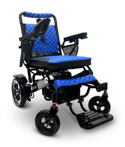The MAJESTIC IQ-7000 Remote Controlled Electric Wheelchair is a sleek and lightweight mobility aid featuring a black frame and a quilted blue seat cushion. It comes equipped with joystick control on the armrest, durable wheels, and a foldable footrest, with the word "Majestic" prominently displayed on its side.