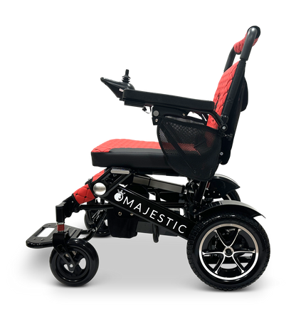 Introducing the MAJESTIC IQ-7000 Remote Controlled Electric Wheelchair: a stylish black and red design featuring a joystick control on the right armrest. This lightweight travel wheelchair highlights a durable frame, cushioned seating, and large rear wheels for enhanced mobility, prominently displaying the Majestic brand name on its side.