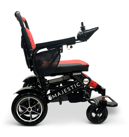 Side view of the MAJESTIC IQ-7000, a black and red lightweight wheelchair featuring an intelligent joystick on the armrest. The sleek Majestic frame highlights large rear wheels and showcases its auto-folding electric capabilities, ensuring seamless and efficient mobility.
