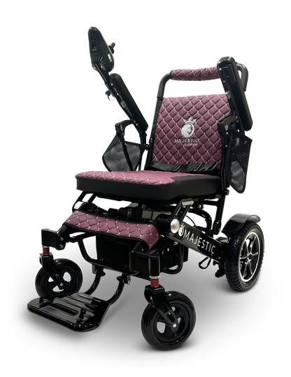 The MAJESTIC IQ-7000 Remote Controlled Electric Wheelchair in black and purple features a quilted seat and backrest. This lightweight marvel comes equipped with adjustable armrests, a footrest, and an intelligent joystick for effortless maneuverability with every turn.