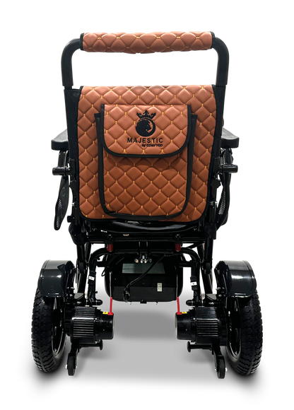 The MAJESTIC IQ-7000 Remote Controlled Electric Wheelchair features a black lightweight design with a quilted brown leather backrest and pouch, proudly displaying the Majestic logo. Its foldable construction unveils the bars, wheels, and motors from the rear view.