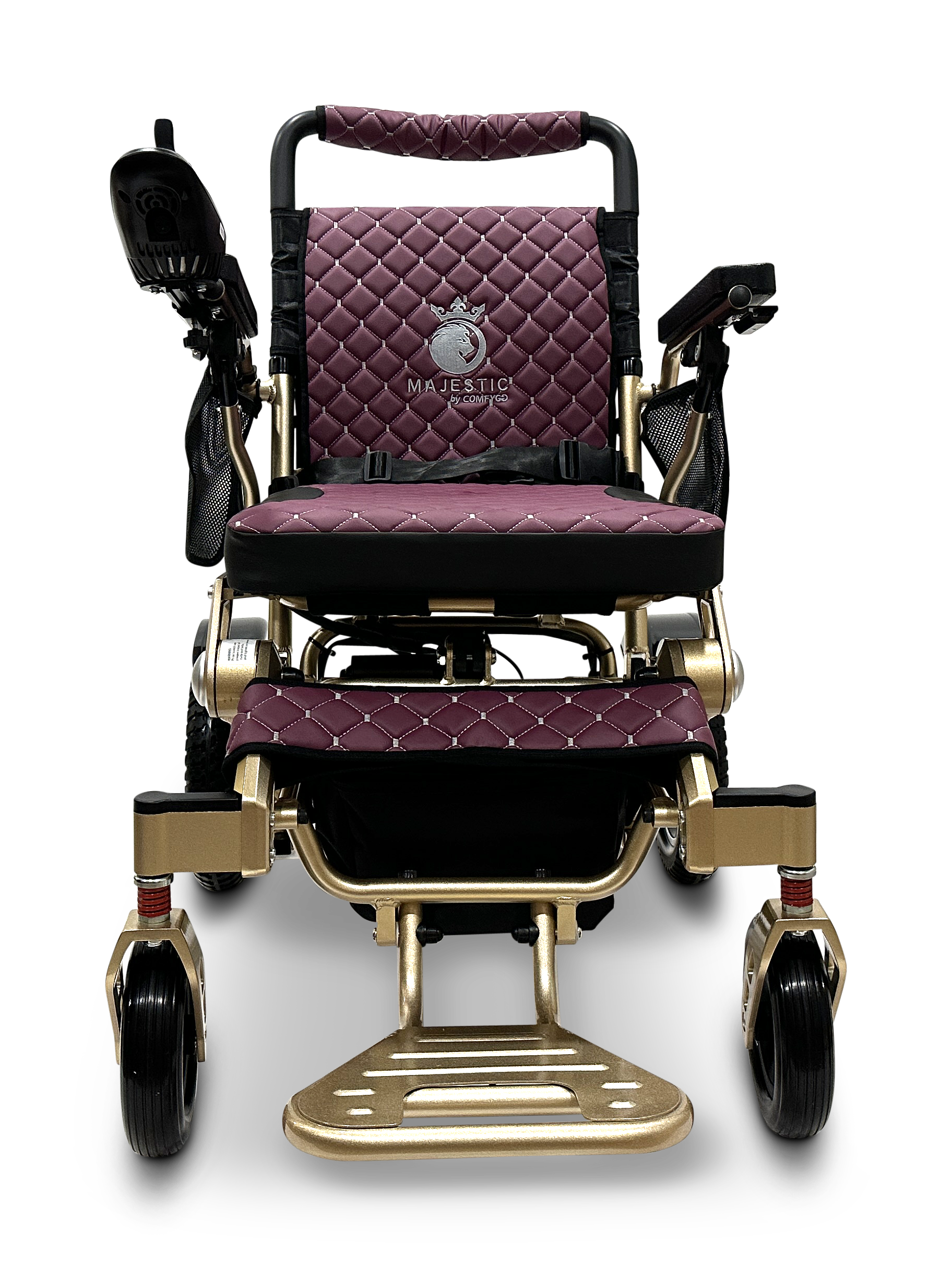 Introducing the MAJESTIC IQ-7000 Remote Controlled Electric Wheelchair, a luxurious folding wheelchair with a quilted burgundy cushion and a golden frame adorned with the Majestic logo. It features supportive armrests, a footrest, and large rear wheels to enhance mobility.