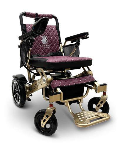 The MAJESTIC IQ-7000 is a stylish and lightweight auto-folding electric wheelchair with quilted purple cushions and a metallic gold frame. It features sturdy wheels, 360-degree joystick control on the armrest, and a branded logo on the backrest.
