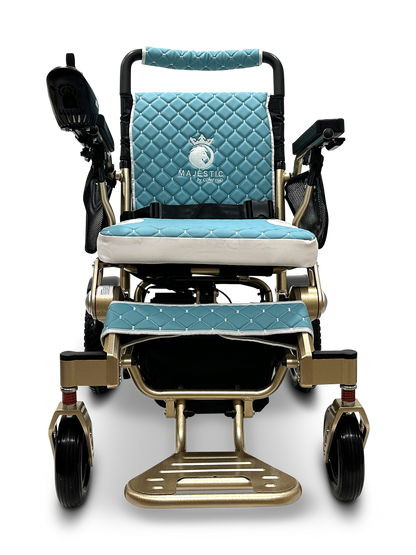 The MAJESTIC IQ-7000 Auto Folding Remote Controlled Electric Wheelchair boasts quilted seat and backrest padding, black armrests, and a footplate for comfort. Its gold and blue design with a 360-degree joystick is elegantly set against a black background for enhanced maneuverability.