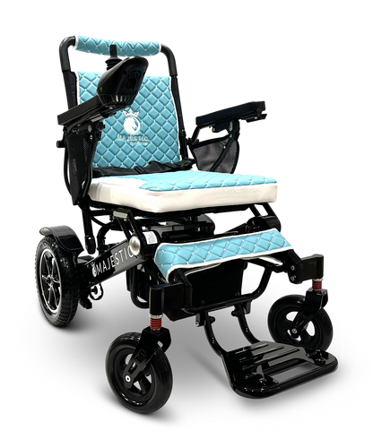 A blue and white MAJESTIC IQ-7000 Auto Folding Remote Controlled Electric Wheelchair with a quilted seat design is showcased. It includes armrests, a footrest, and an intelligent joystick positioned on its control panel. The name "Majestic" is prominently displayed on the frame. Set against a black background, this wheelchair merges elegance with advanced technology.