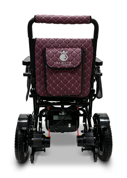 The MAJESTIC IQ-7000 Remote Controlled Electric Wheelchair, available in black and burgundy, features quilted fabric on the backrest and a convenient storage pocket. Designed for modern travel, it offers large rear wheels and small front wheels to ensure easy maneuverability wherever you go.