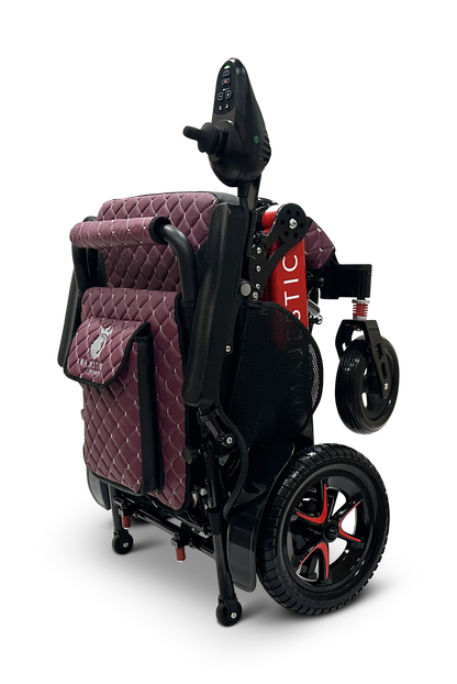 Showcased against a sleek black background is the MAJESTIC IQ-7000 Auto Folding Remote Controlled Electric Wheelchair, featuring a folded design in red and black with quilted maroon cushioning, an intelligent joystick, and sturdy black wheels accented in red.