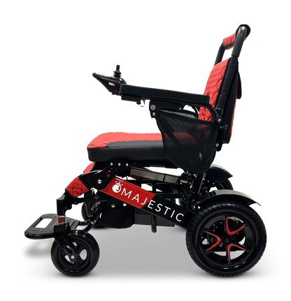 The MAJESTIC IQ-7000 Remote Controlled Electric Wheelchair is an auto-folding model in red and black, featuring a cushioned seat and intelligent joystick controls. It has the word "Majestic" on the side, a mesh side pocket, and sturdy wheels set against a black backdrop.