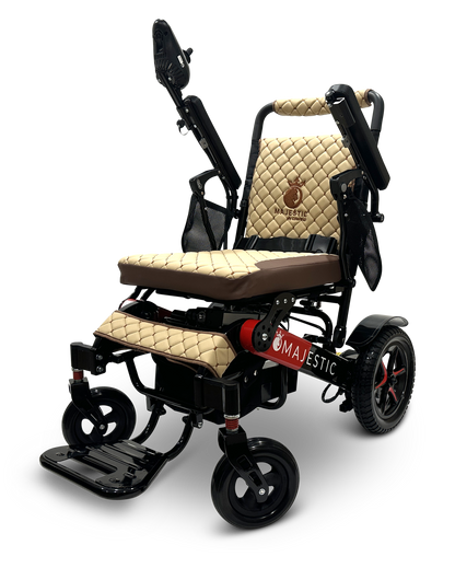 Introducing the MAJESTIC IQ-7000 Remote Controlled Electric Wheelchair: a stylish and lightweight mobility solution featuring quilted beige cushioning, adjustable armrests, and a sleek black frame. Enhanced with auto-folding technology for convenience, this wheelchair prominently displays its Majestic branding on the side. Its four wheels provide enhanced stability and maneuverability.