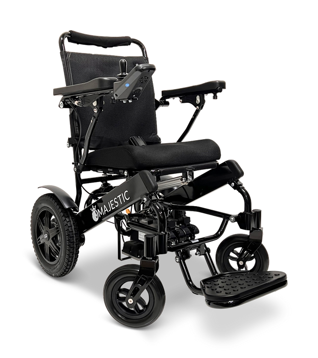 The ComfyGo MAJESTIC IQ-9000 Auto Folding Electric Wheelchair features a sleek black frame with a cozy cushion. It's equipped with brushless silent motors and a digital joystick controller on the armrest for easy maneuvering. It glides smoothly on two large rear wheels and two smaller front ones, while the Majestic brand is prominently displayed on the side.