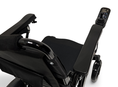 Close-up view of the ComfyGo MAJESTIC IQ-9000 Auto Reclining Electric Wheelchair, showcasing its armrest, seat, and digital joystick controller with display. Made from aircraft-grade aluminum alloy. Transparent background.