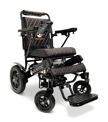 The ComfyGo MAJESTIC IQ-9000 Auto Reclining Electric Wheelchair features a black and red foldable design, padded seat/backrest, armrests, footrest, large rear wheels, digital joystick controller, aircraft-grade aluminum frame, and Majestic logo on the side.