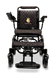 Introducing the ComfyGo MAJESTIC IQ-9000 Auto Folding Electric Wheelchair, a sleek black model featuring a quilted seat and backrest design with red stitching and an elegant gold logo. It comes equipped with brushless silent motors, armrests, and a digital joystick controller on the left arm for effortless navigation.