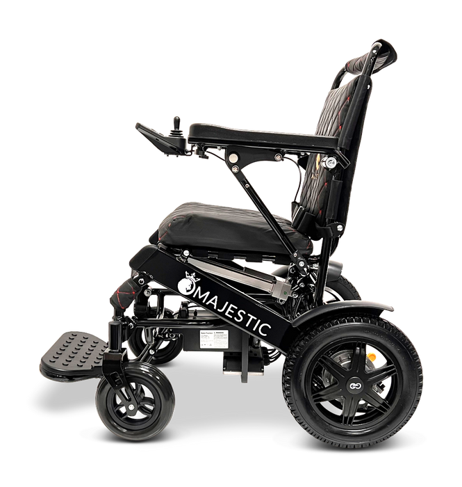 Side view of the sleek, modern black ComfyGo MAJESTIC IQ-9000 Auto Folding Electric Wheelchair featuring a digital joystick controller and brushless silent motors, its design includes a comfortable seat, footrest, and large rear wheels against a plain black background.